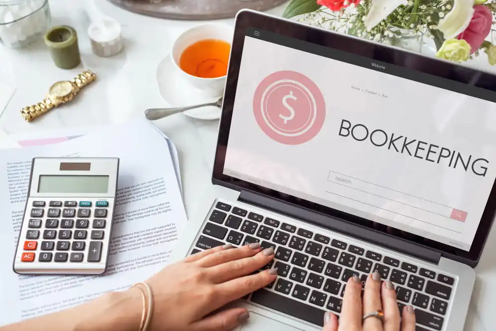 A laptop showing a digital bookkeeping interface with charts and financial data for efficient record-keeping.